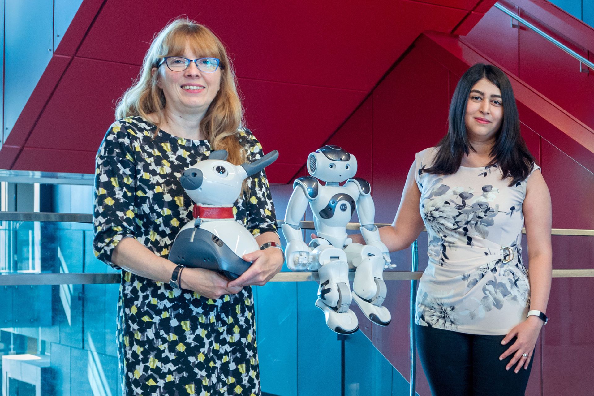 University of Waterloo professors Dr. Moojan Ghafurian and Dr. Kerstin Dautenhahn posing with a couple of robots. 