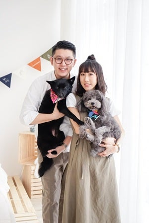 Couple holding their dogs.