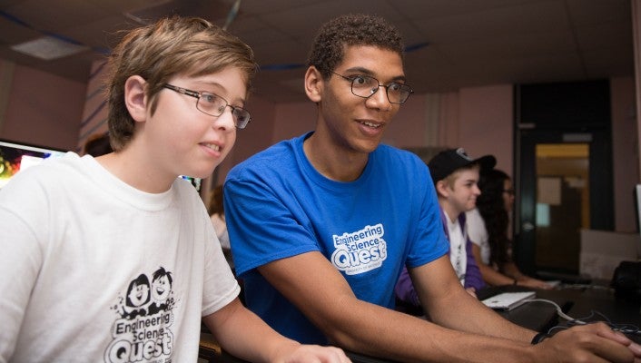 Eric Gemnay helps camper in ESQ's technology camp