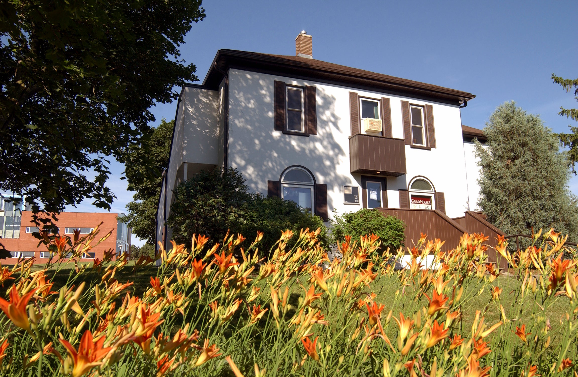 Grad house with tiger lillies in front