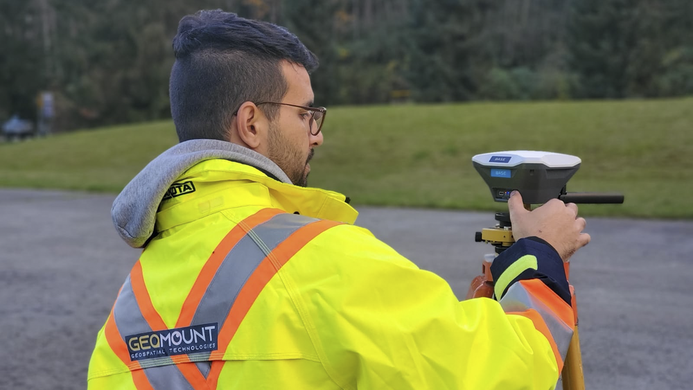 Hasti Shwan operating a sensor outdoors wearing Geomount safety jacket
