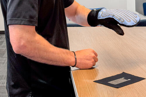 James Pickard demonstrating a prototype mitt with sensors