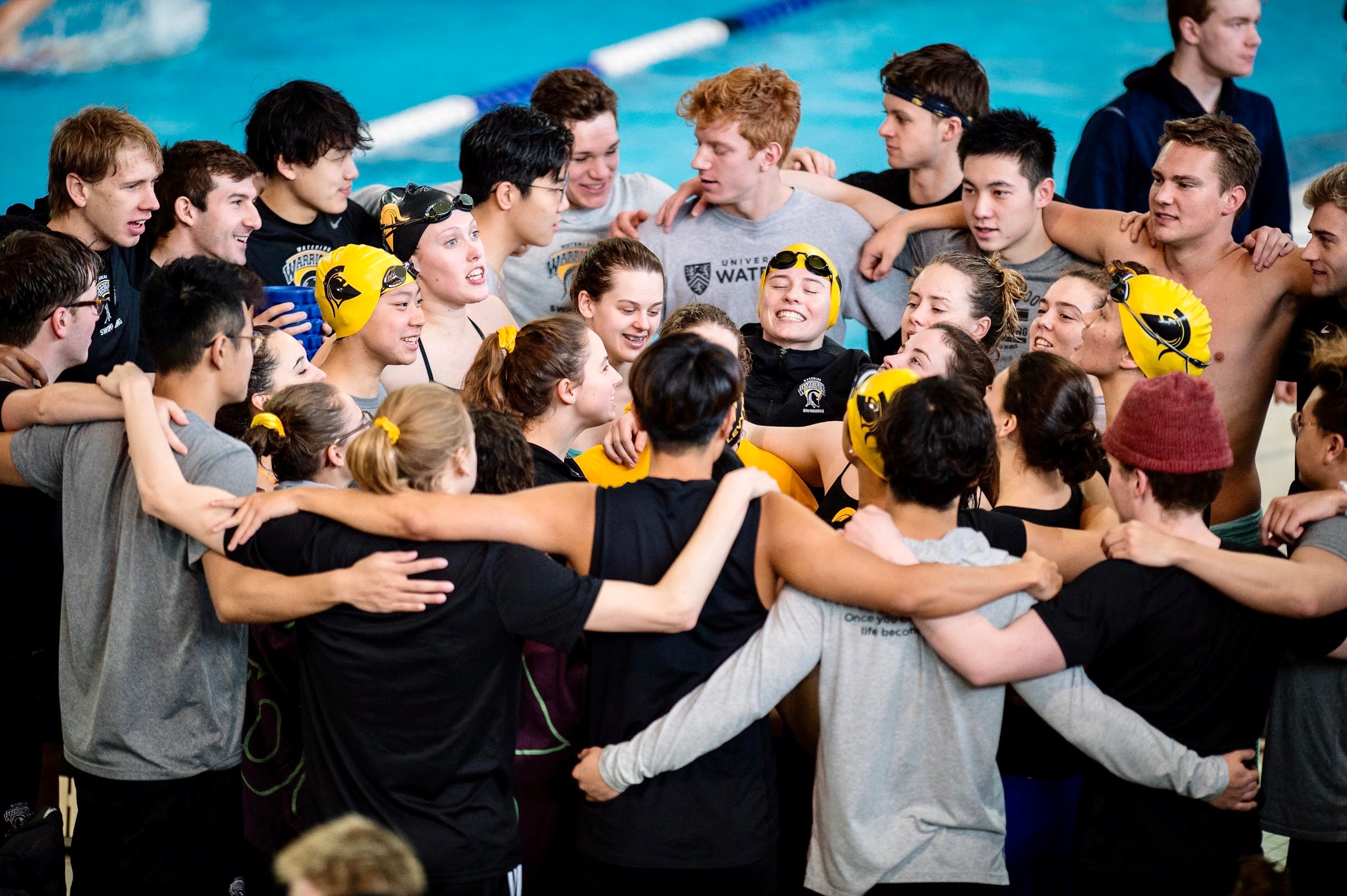 Bumbulis (far right, in profile, wearing yellow swim cap) celebrates with her teammates 