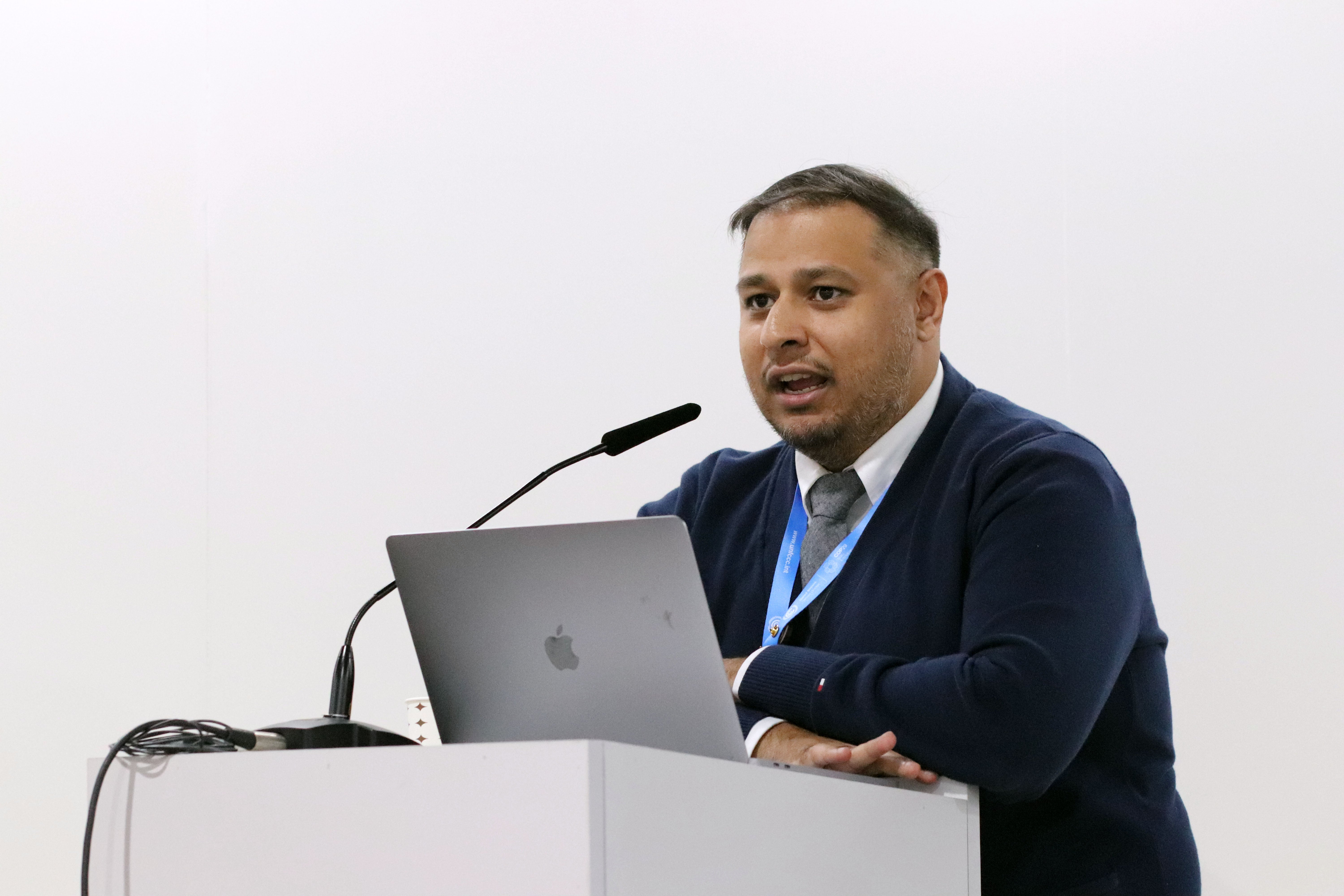 Shahan Salim stands at a podium