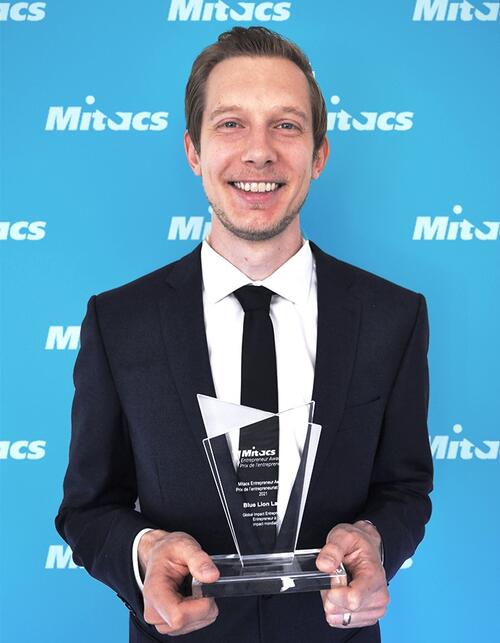 Jason Deglint poses with his Mitacs Entepreneur Award.