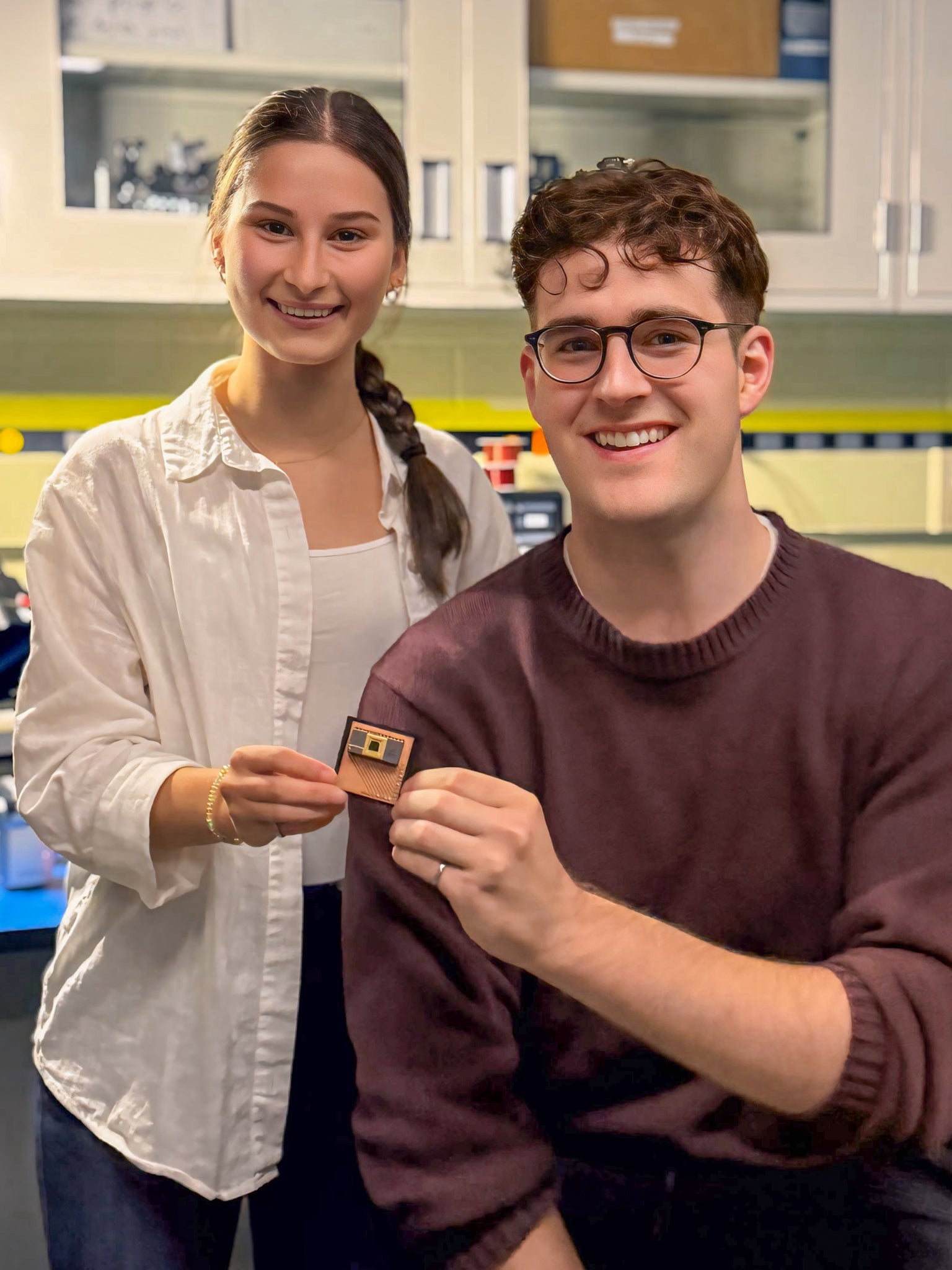 Sarah Odinotski and Jack deGooyer holding the finished camera product inside a lab