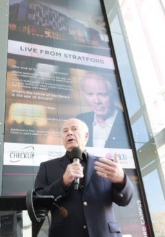 Peter Mansbridge in front of the digital tile wall