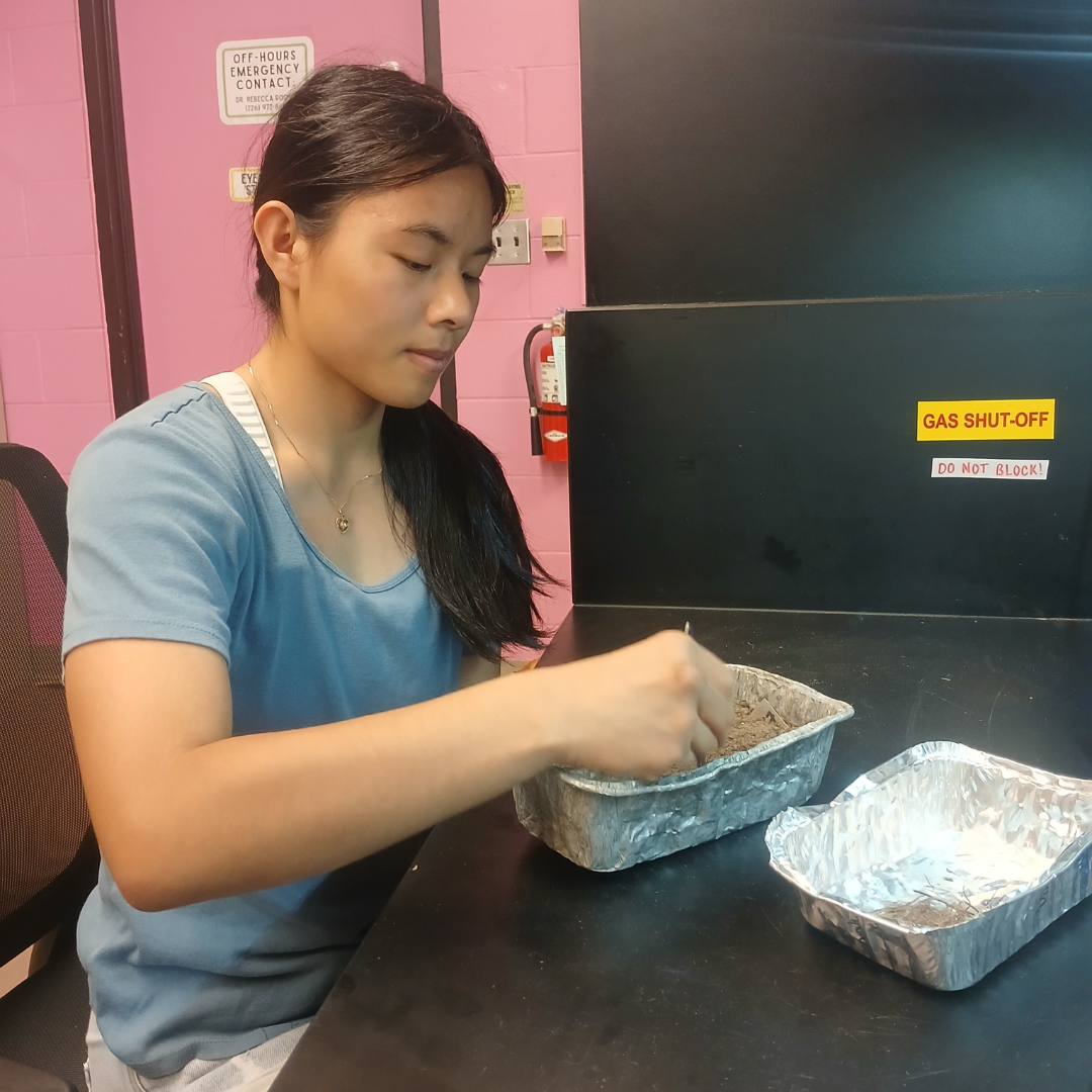 Mia analyzing soil samples in the lab