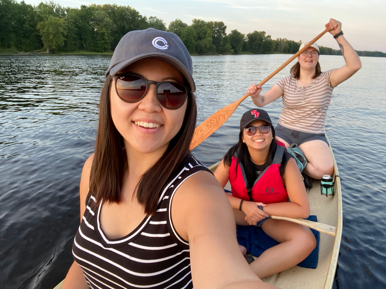 Michelle Liu (left) and Allie Kennington (right) and a good friend enjoy canoeing on the Ottawa River near Rockcliffe.