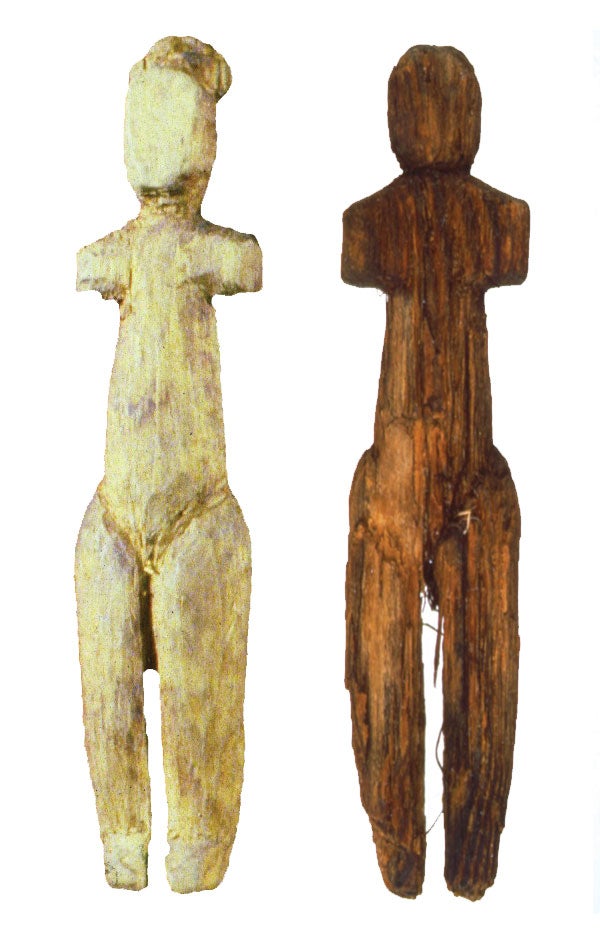 Two wooden objects roughly shaped like a person
