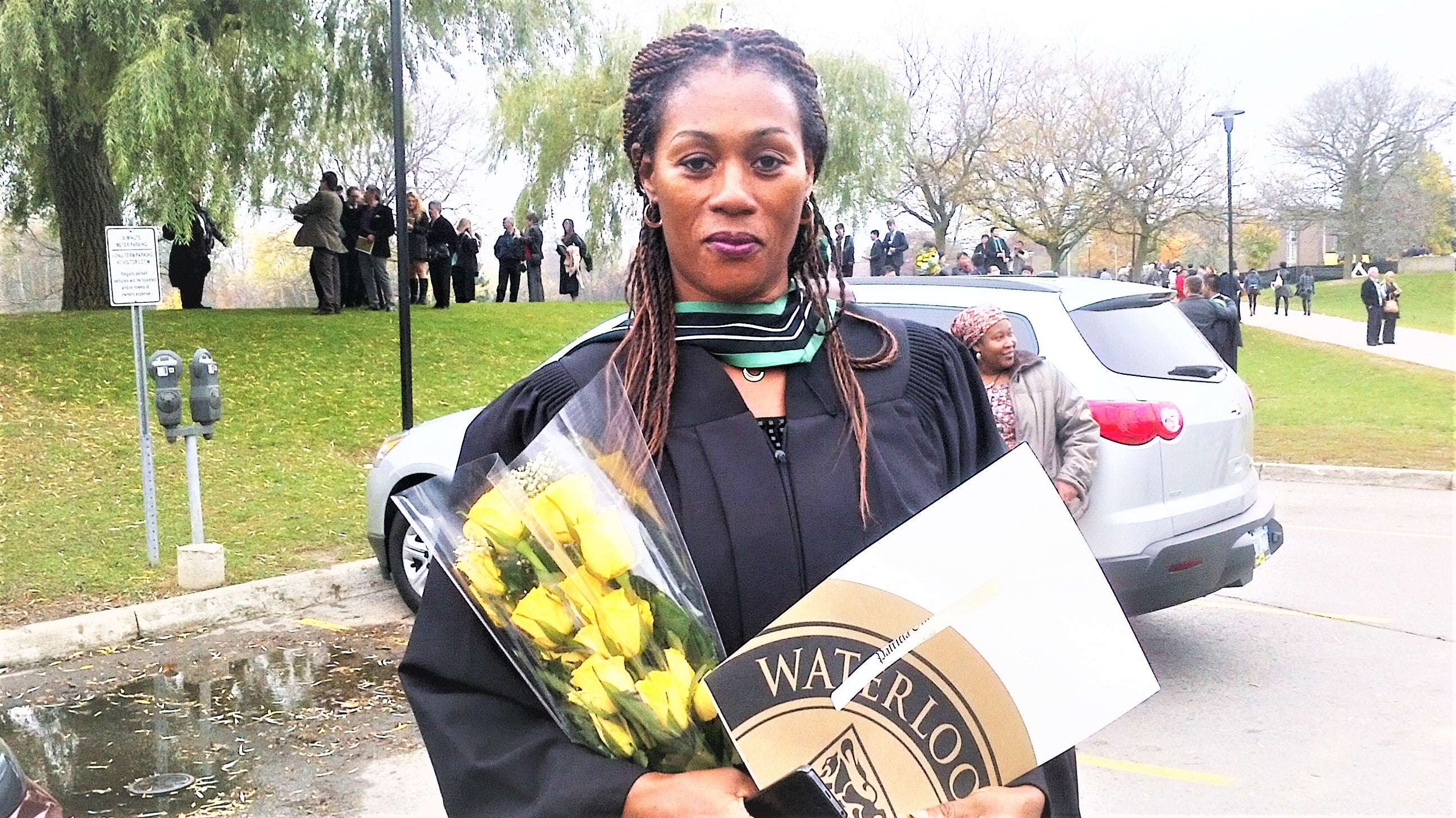 Patricia Ofili holding bouqet and degree
