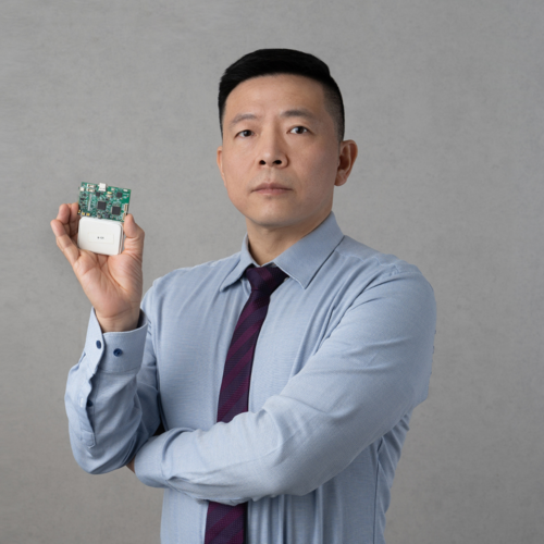 Headshot of professor Ning Jiang holding a computer chip