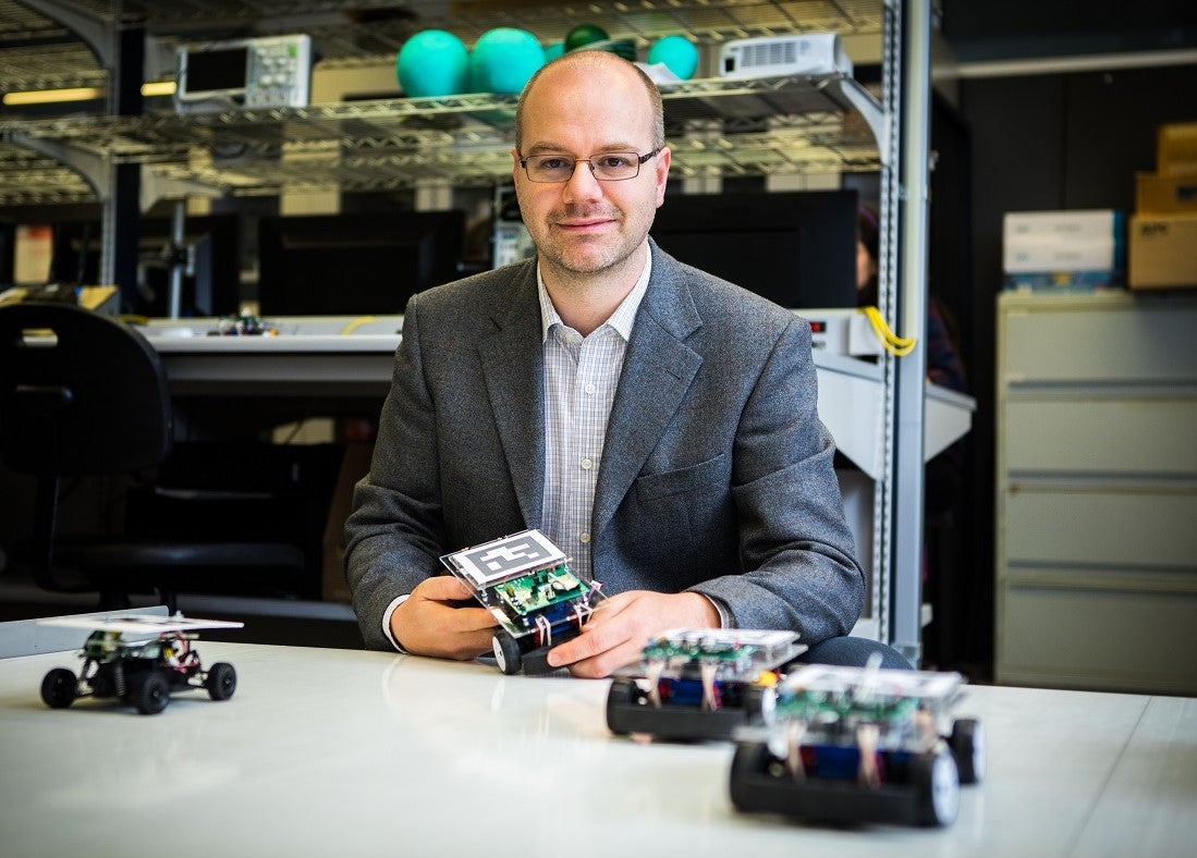Sebastian Fischmeister poses for a photo in his lab at Waterloo Engineering.