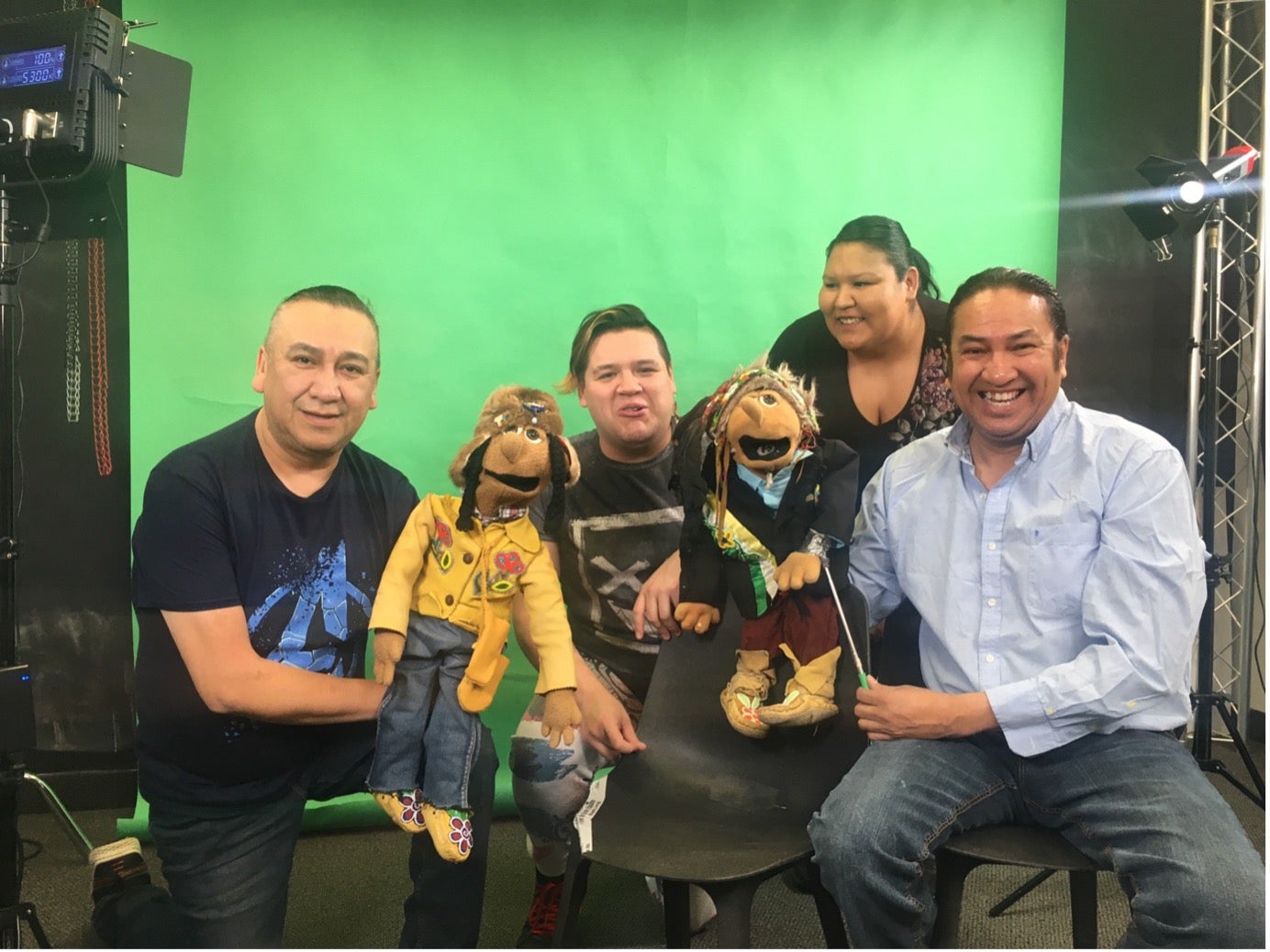 Performers of the songs in the key of Cree posing for a photo in front of a green screen