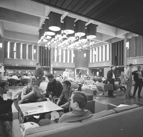 Students play cards in the great hall of the Campus Centre, circa 1968