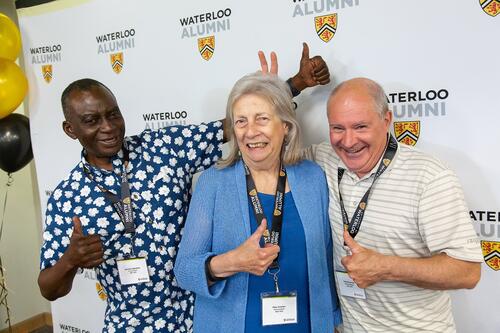 Alumni give the thumbs up (and bunny ears!)