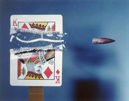 Playing card cut in half by bullet