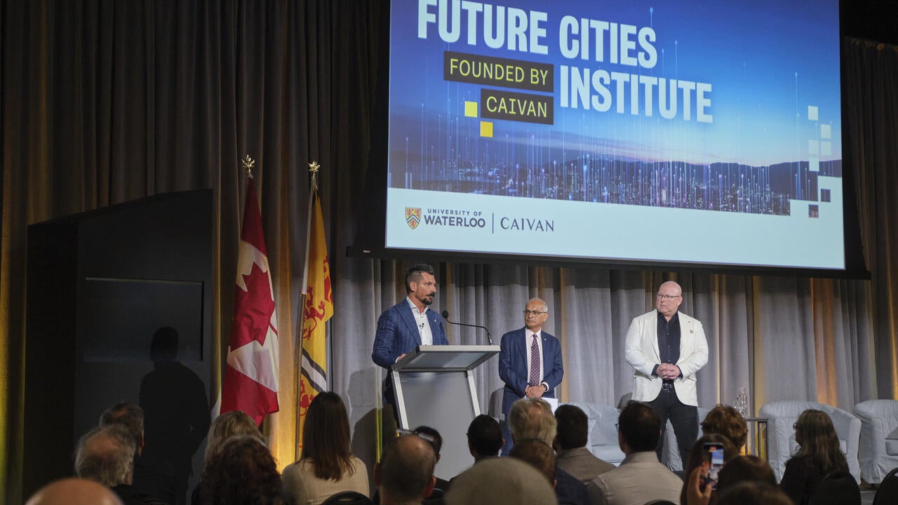 Frank Caivan (left), Vivek Goel (centre), Troy van Haastrecht (right) standing on stage during launch of Future Cities Institute