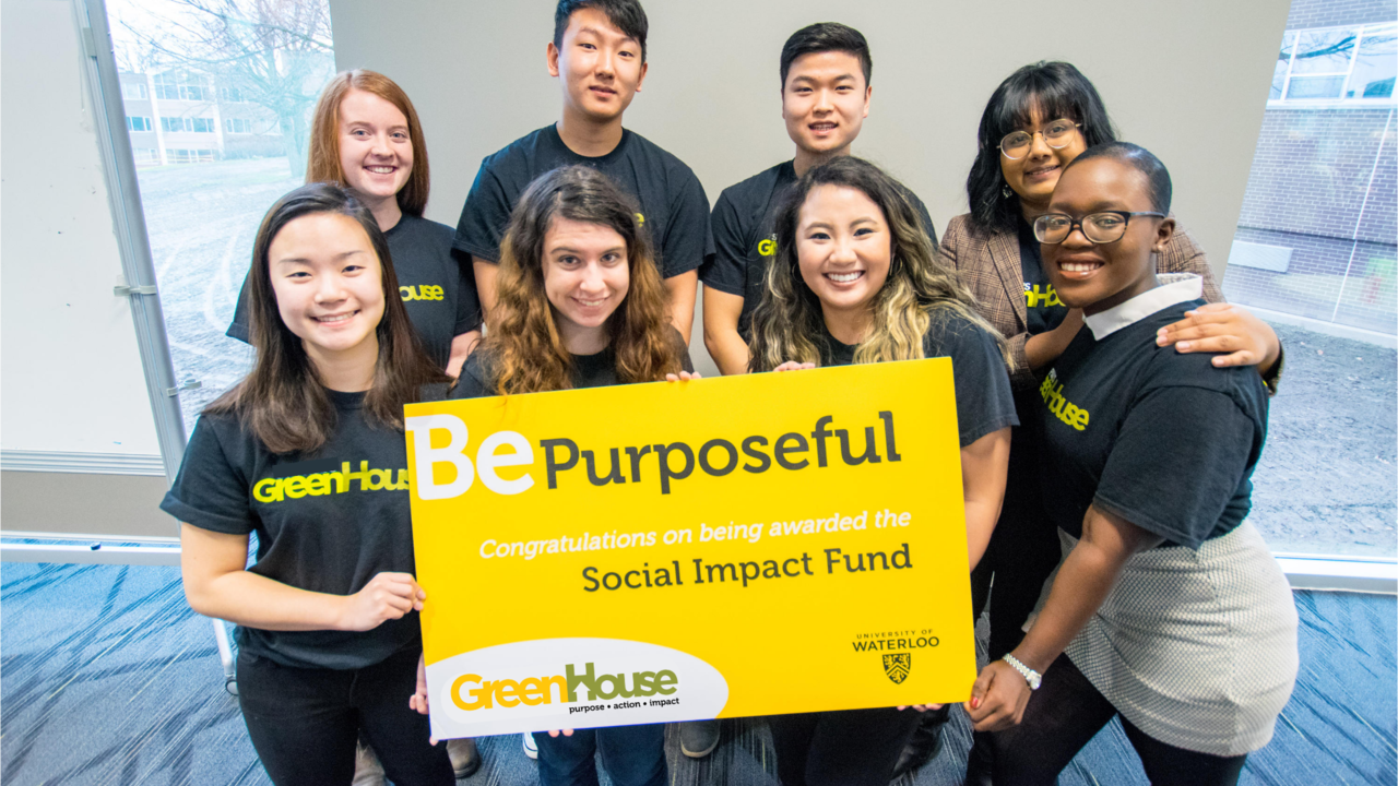 GreenHouse students smile at the camera with Social Impact Fund cheque