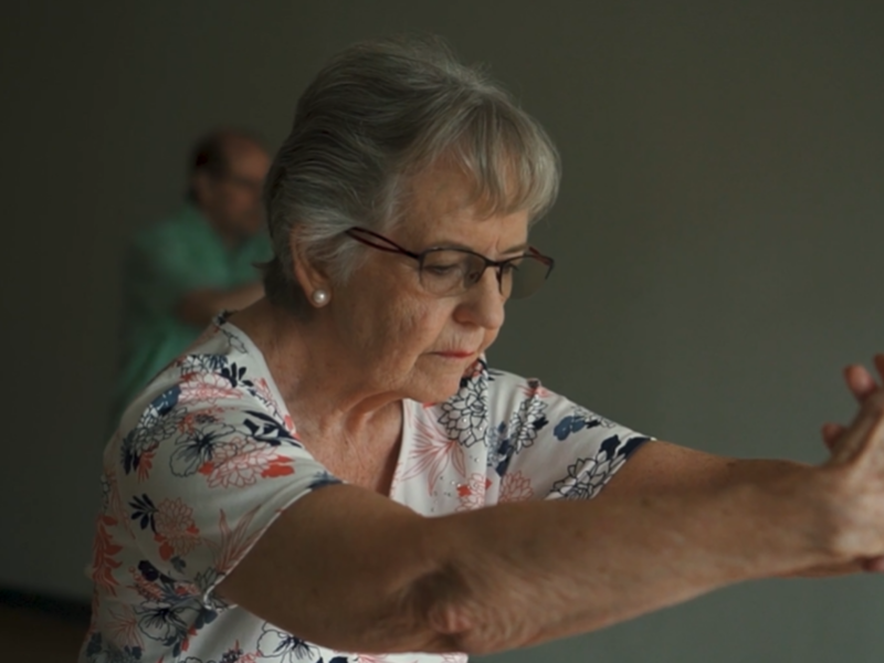 Older woman stretching arms in front of her