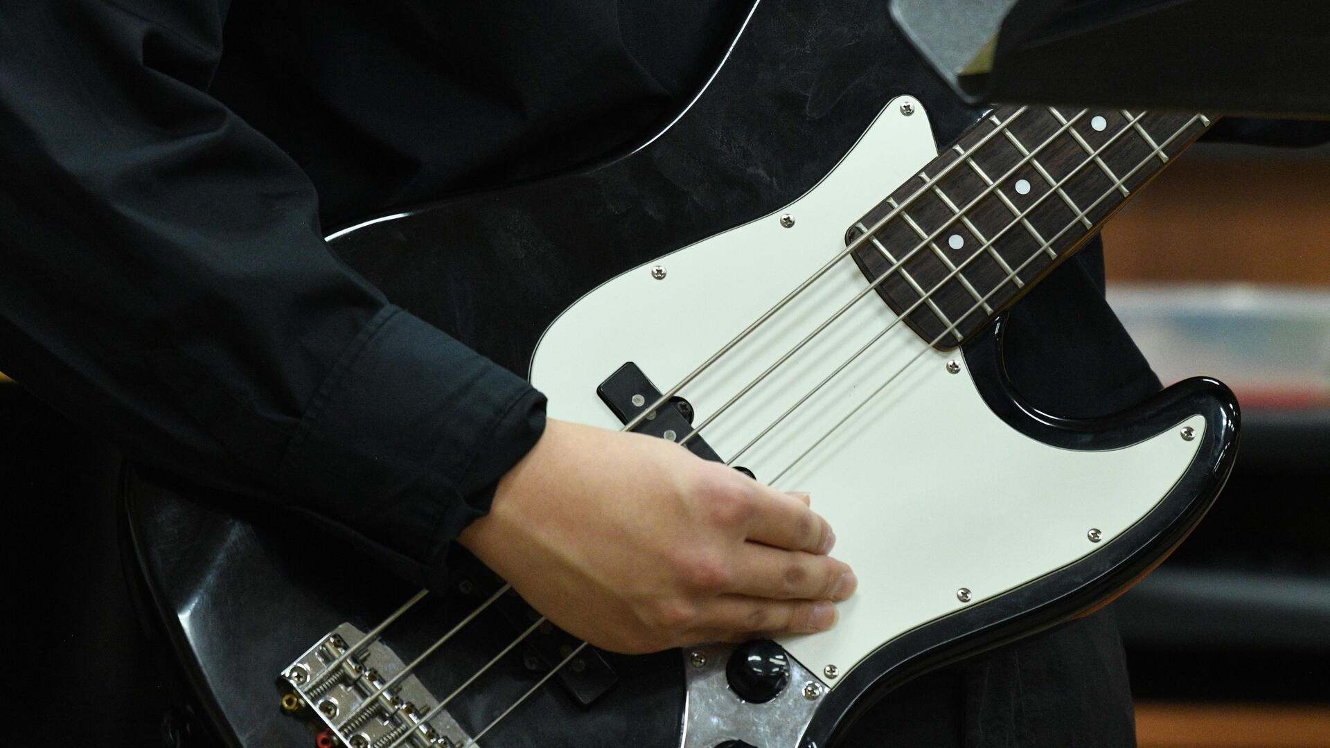 A student plays bass guitar 