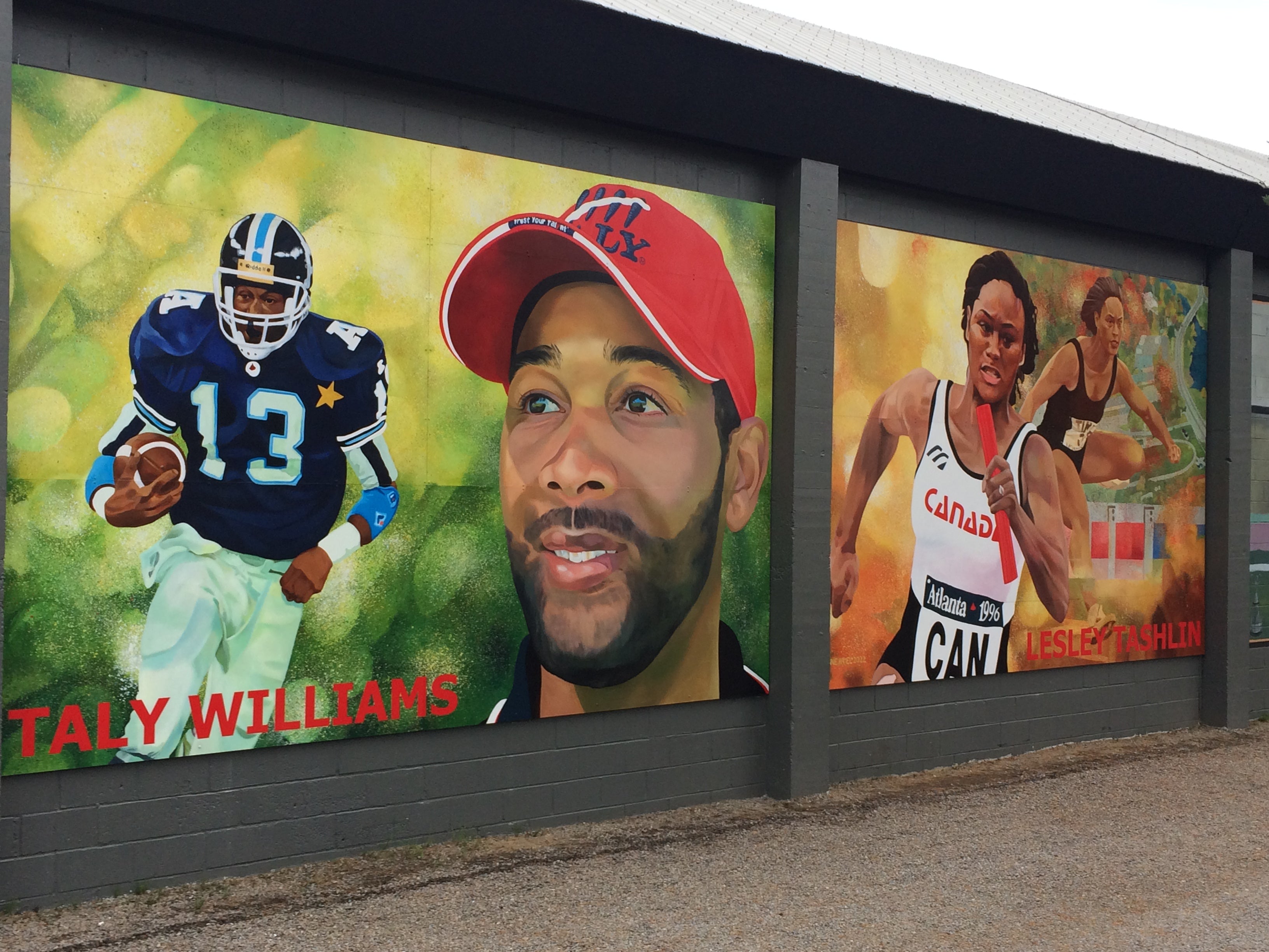 Murals of Taly Williams and his sister Lesley Tashlin on the arena wall in their hometown of Haliburton, Ontario.