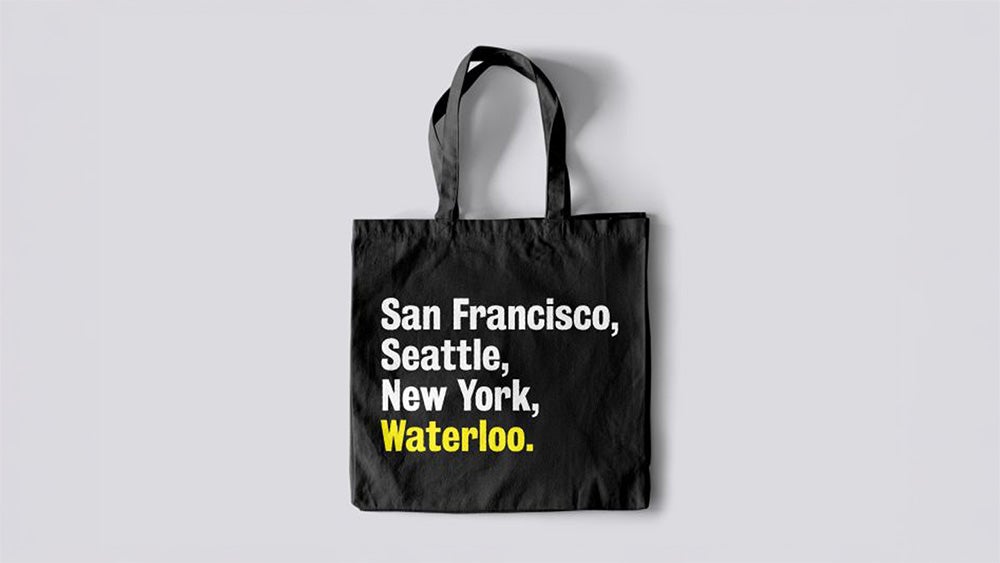 A black tote bag with the words San Francisco, Seattle, New York and Waterloo highlighted in yellow.