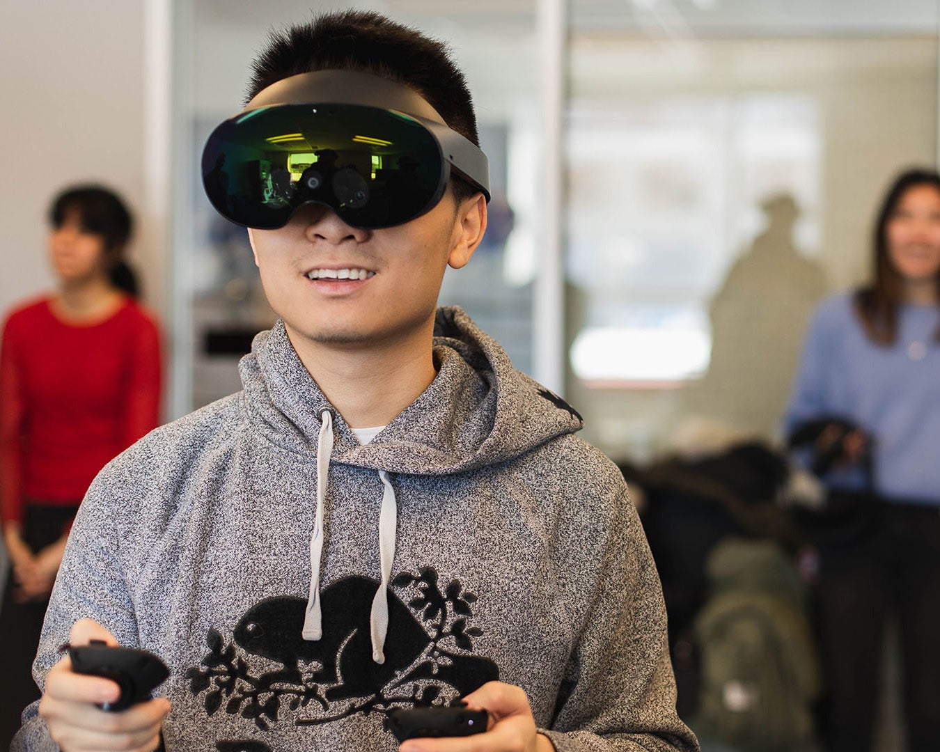 A student smiles while using VR equipment in a classroom