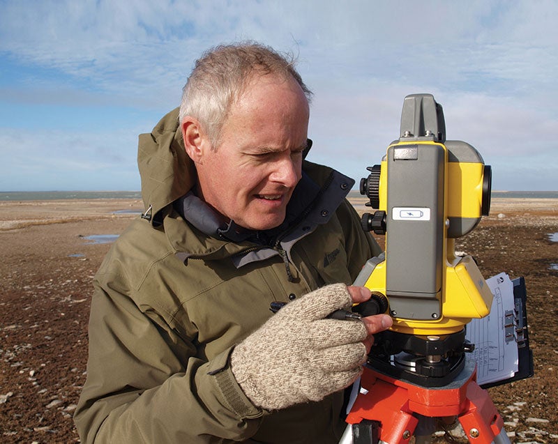 Robert Park in the Arctic using equipment to take measurements
