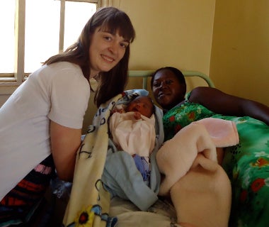 Christina Marchand with a mother and baby in Uganda