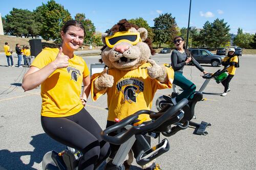 The spin class instructor gives a thumbs up with King Warrior