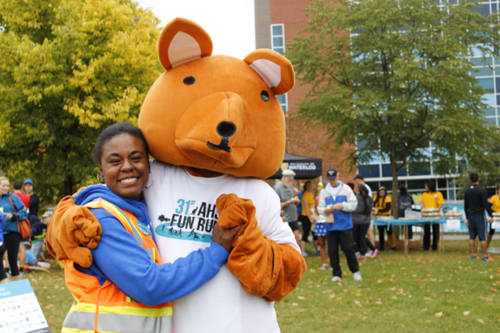 Fun Run volunteer poses with a kangaroo mascot