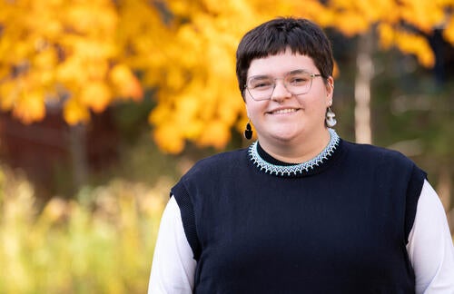Tara Ryan poses near foliage with fall colours