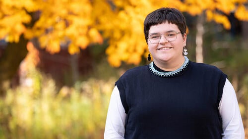 Tara Ryan poses near foliage with fall colours