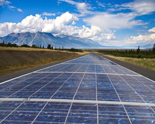 A road paved with solar cells runs to the horizon.