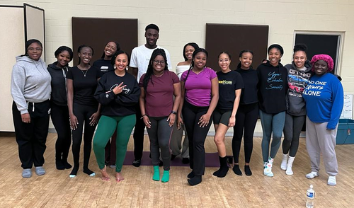 Black students pose after their yoga session