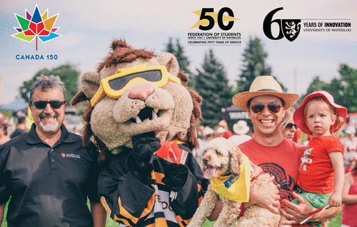 President Feridun Hamdullahpur with King Warrior and a man holding a child and a dog at Canada Day festivities