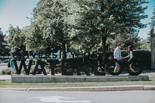 Couple beside the Waterloo sign.