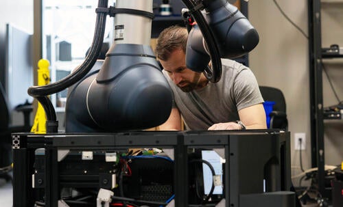 Ryan Gariepy examins a robot