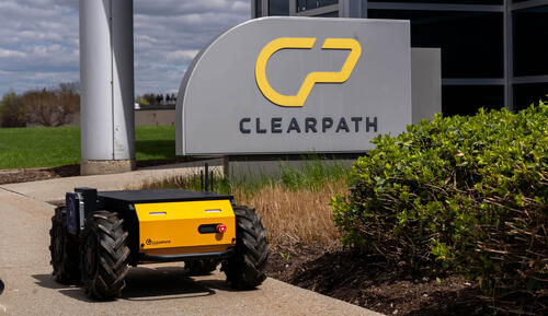 Rover drives in front of Clearpath sign