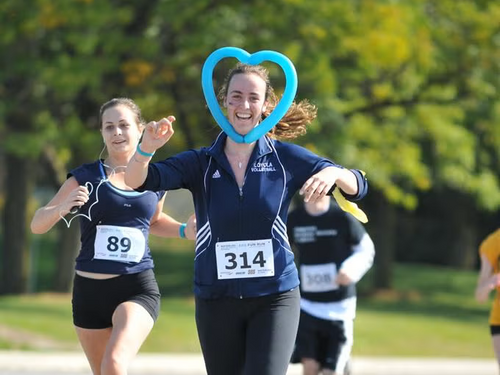 Runner completes the race with a teal heart around her head