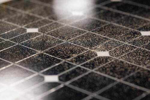 As more dust and sand accumulate on a solar panel surface, it significantly reduces the amount of sunlight that can reach the pa