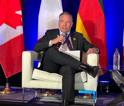 Mark Schaan seated and speaking into microphone