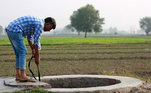 A man draws water from a well in India.
