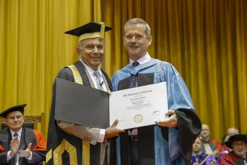 Chris Hadfield receives his honourary doctor of science degree from Prem Watsa, Chancellor of the University of Waterloo.
