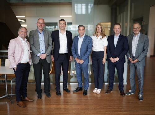 Mark Schaan and Evan Solomon pose with members of the Institute for Quantum Computing