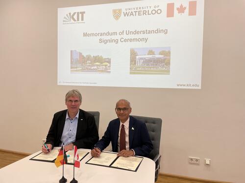 KIT President Holger Hanselka and University of Waterloo President Goel pose while signing MOU
