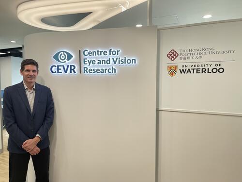 Dr. Ben Thompson standing beside the logos for CEVR, Hong Kong Polytechnic University, and University of Waterloo