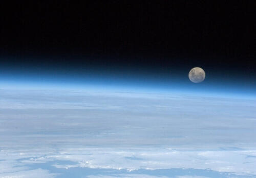 Moon rising over the Earth's horizon.