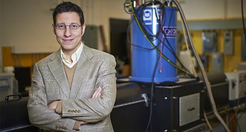 Professor Pavle Radovanovic in front of the magnetic circular dichroism system used in this study.